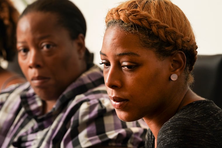 Rashena Carter, left, and her daughter LeToya Ramseure, right, meet with advocates to discuss Ramseure's case, in which she fatally shot her ex-boyfriend with his gun after he burst into her home.