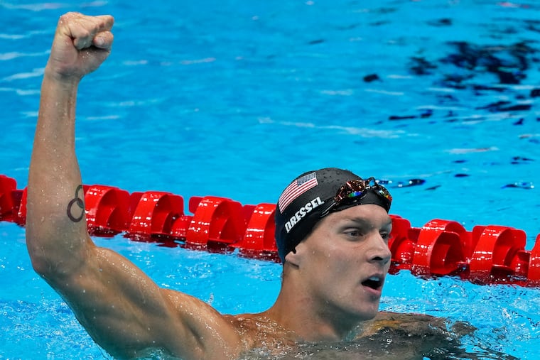 Caeleb Dressel celebrates winning the gold medal the men's 50-meter freestyle.