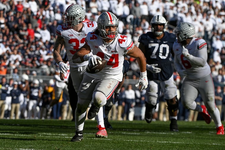 Ohio State defensive end J.T. Tuimoloau (44) returns an interception for a touchdown during the fourth quarter against Penn State. Ohio State won, 44-31.