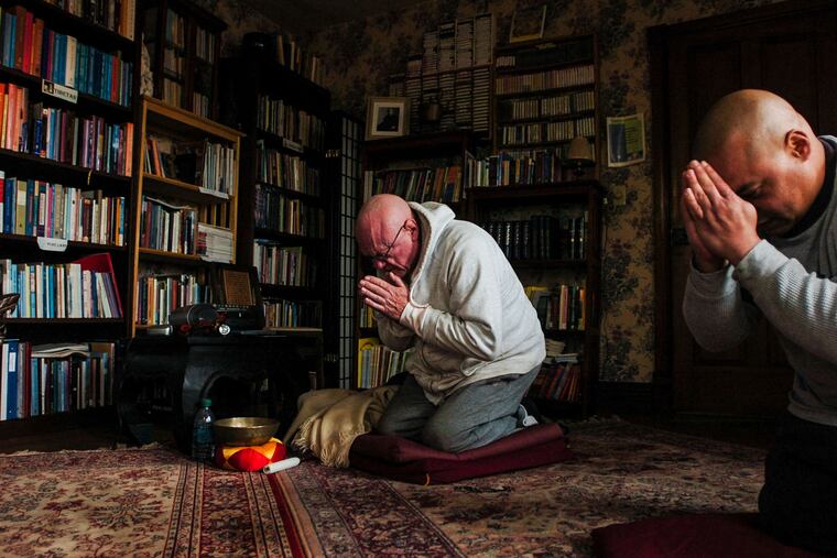 John Mulligan (left) and Angel Correa performing their daily meditation at Bodhi House in Mount Joy Township.
