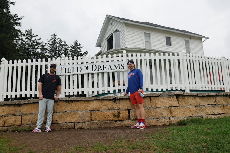 The Phillies’ Bryce Harper and Bryson Stott pose for a photo at the farmhouse from “Field of Dreams” before their game on Thursday in Dyersville, Iowa.
\