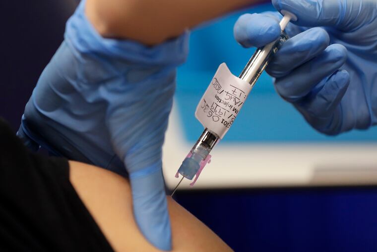 Volunteer Yash is injected with the vaccine as part of an Imperial College vaccine trial, at a clinic in London, Wednesday, Aug. 5, 2020.