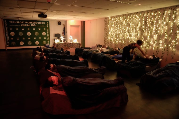 Transit workers take part in a guided relaxation class in 2024 in Brooklyn. Managing stress can help us reduce daily anxiety. (AP Photo/Frank Franklin II)