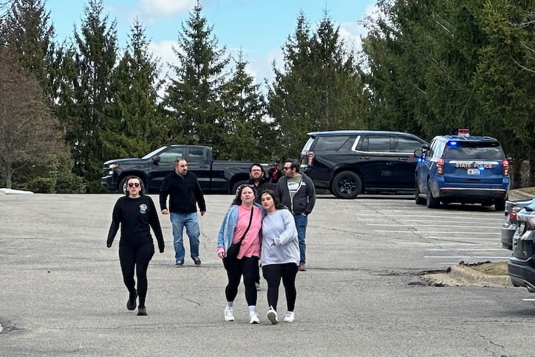 People gather near Temple Israel synagogue in West Bloomfield Township, Mich.