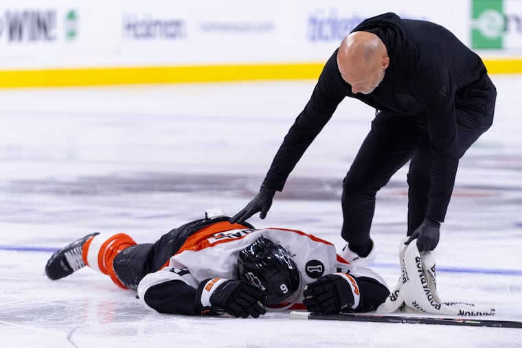 Flyers defenseman Jamie Drysdale lays on the ice after a hit by the Ducks' Ross Johnston. Drysdale did not return.