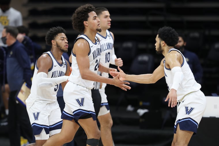 Jeremiah Robinson-Earl, center of Villanova is congratulated by teammates as Marquette call a timeout during the 2nd half on Feb. 10, 2021 at the Finneran Pavilion at Villanova University. Robinson-Earl was 5-5 from beyond the 3-point line.