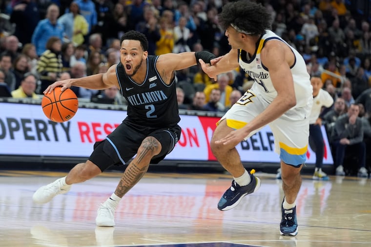 Villanova's Mark Armstrong tries to get past Marquette's Stevie Mitchell during their game Monday in Milwaukee. Marquette won, 87-74.
