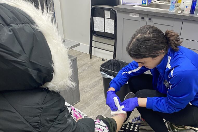 Eleanor Turi changes the dressings on the wound of a patient at a clinic in Kensington on Wednesday, Dec. 4, 2024.