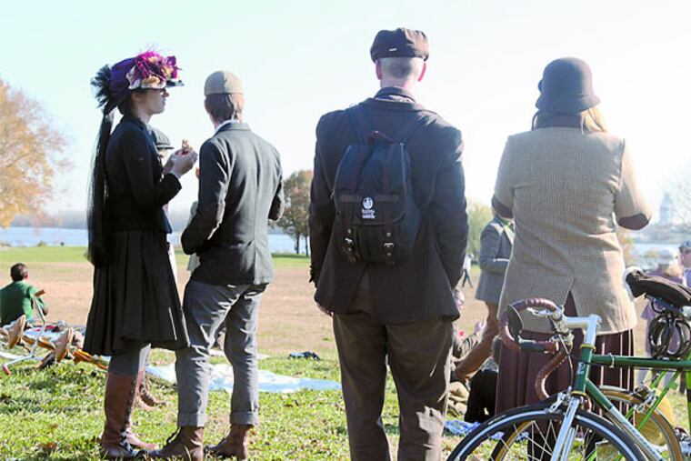 Attendees of the 5th annual tweed ride lounge in their apparel before their bike ride. ( RYAN S. GREENBERG / Staff Photographer )