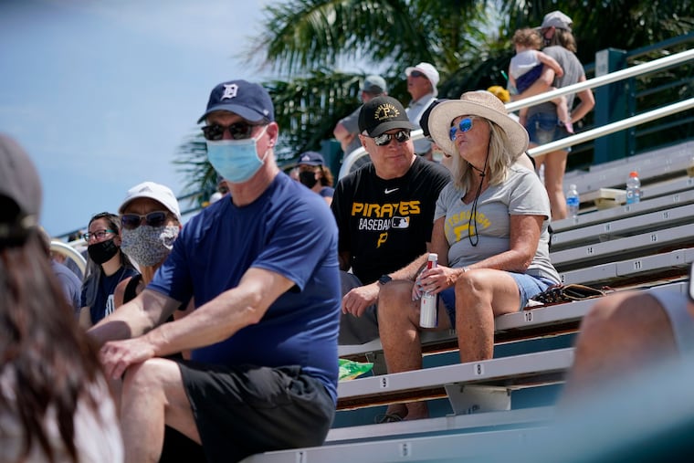 A limited number of socially distanced fans watch a spring training exhibition baseball game between the Pittsburgh Pirates and the Detroit Tigers at LECOM Park in Bradenton, Fla., March 26. Spring has arrived, and many older adults who have been vaccinated are emerging from hibernation imposed by the coronavirus pandemic.