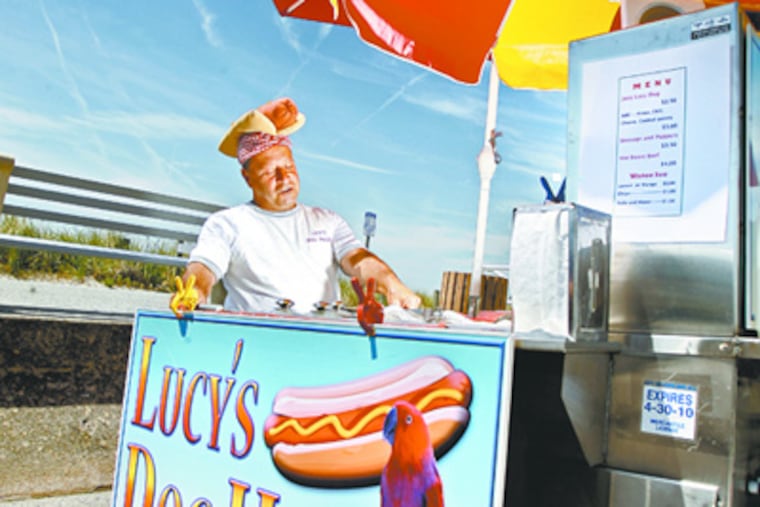 Joe Paruta mans his cart, Lucy's Dog House, at Beach and First Avenues in Cape May. A new ordinance in the resort increased the number of permits for military veterans who sell refreshments from pushcarts, causing friction among them. (Elizabeth Robertson / Staff Photographer)