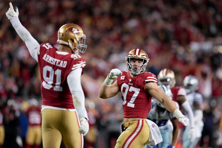 San Francisco 49ers defensive ends Arik Armstead and Nick Bosa react after tackling Dallas Cowboys quarterback Dak Prescott during the second half Sunday.