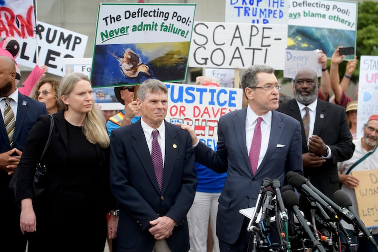 Former Olympic canoeist David Hearn (second from left) listens as his attorney Norman Eisen (right) speaks after he pleaded not guilty to allegedly damaging the Lincoln Memorial Reflecting Pool, Thursday, July 9, 2026, in Washington. On Friday the Justice Department dropped the charges.