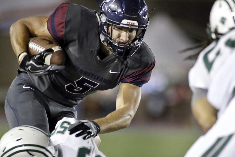 Dartmouth’s Eric Meile pulls down Penn’s Justin Watson in the second quarter Friday.
