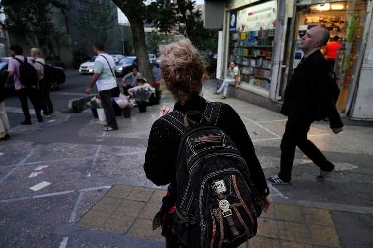 An Iranian woman without a mandatory headscarf, or hijab, walks in downtown Tehran, Iran, during protests on June 10, 2024. An Iranian singer who performed without hijab has been sentenced to 74 lashes.
