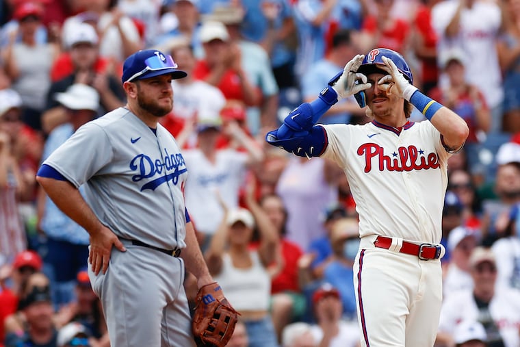 The Phillies' Bryson Stott puts his fingers to his eyes after hitting a seventh-inning triple past Dodgers third baseman Max Muncy on Sunday.