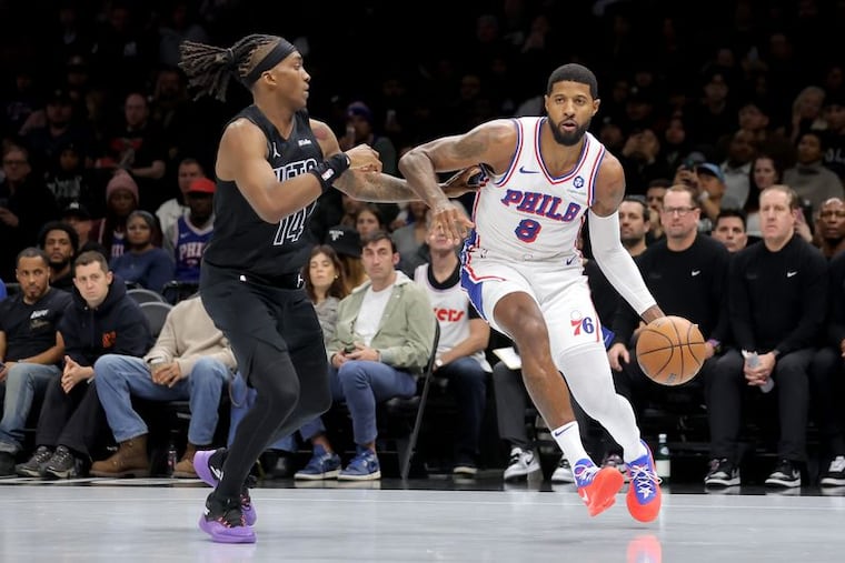 Sixers' Paul George (right) scored 14 points in his team's win over the Nets on Friday.