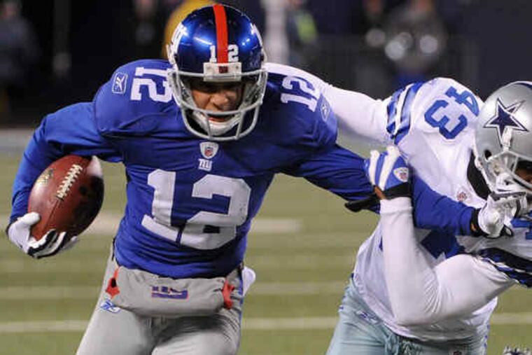 The Giants' Steve Smith, stiff-arming the Cowboys' Gerald Sensabaugh, will work against the nickel back.