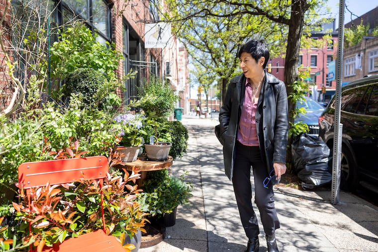Ellen Yin browses the selection outside of Seasons Flowers, 211 Arch St. 