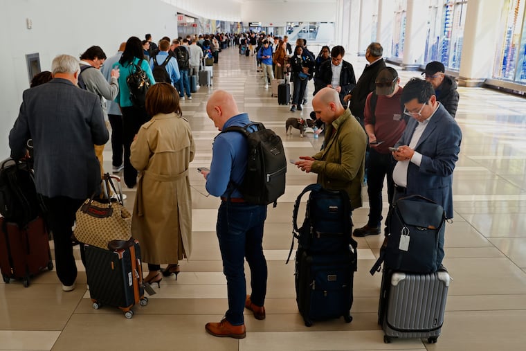 Passengers wait in the TSA Pre-Check line at LaGuardia Airport in East Elmhurst, New York on Thursday.
