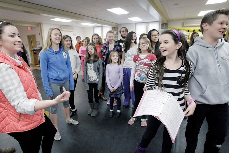 Choreography Director Kaitlin Tumulty (left), Juliet Morgan, 11, Ryan Coggan (far right) and the rest of the cast rehearse the scene "Stop Thief" during a Moorestown Theater Company rehearsal of 'Magic Tree House: A Ghost Tale for Mr. Dickens, Jr.' ( ELIZABETH ROBERTSON / Staff Photographer )