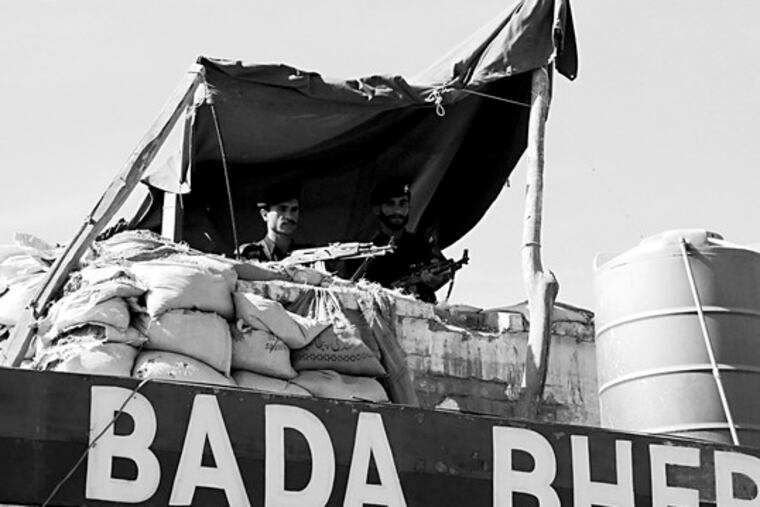 Pakistani police officers staff a fortified position over a police station on the outskirts of Peshawar. Attacks on police rose from 113 in 2005 to 1,820 last year.