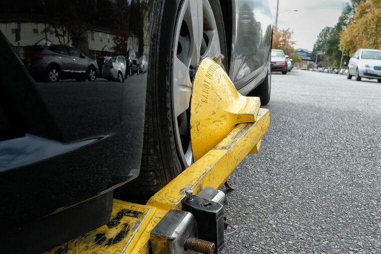 PPA booted a vehicle parked on the corner of 46th Street and Mandela in west Philadelphia as part of the agency crack down on unpaid parking tickets. ED HILLE / Staff Photographer