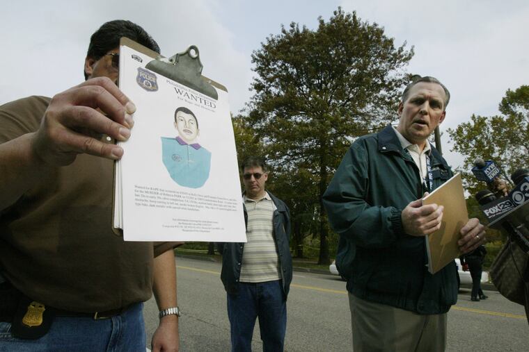 Philadelphia Police Captain John Darby of the Special Victims Unit looks towards a composite sketch of a rapist wanted by Philadelphia police. It's suspected that a man fitting the composite sketch was also involved in a recent assault on a lone jogger near West River Drive in Philadelphia. Photo from press conference on Sunday afternoon, Oct. 26, 2003.