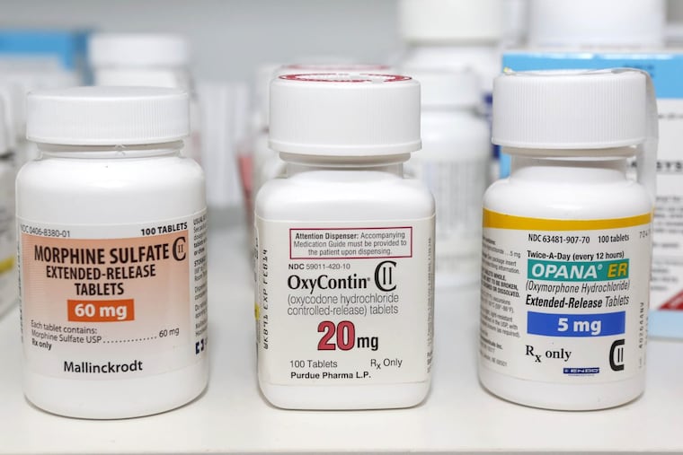 Containers of the opioid-containing drugs morphine sulfate, OxyContin and Opana, in a 2013 photo.