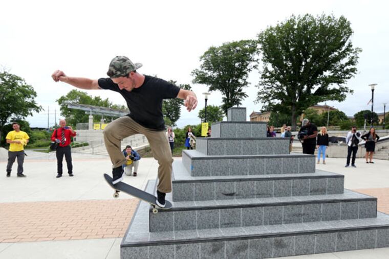 Chris Mathis of Philadelphia skates the pyramid half of the sculpture. Even before the work was unveiled, bikers and skateboarders had partaken of the art. (DAVID SWANSON / Staff Photographer)