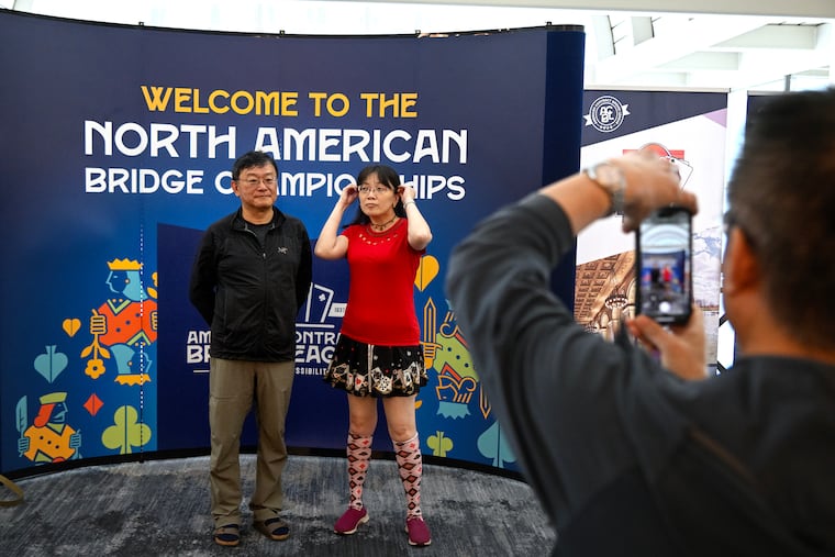 Winston Huang (left) of San Francisco poses with his bridge coach, Ho-Yee So from Taipei, Taiwan (suited up in heart, club, diamond and spade shirt, socks and skirt) during a break at the North American Bridge Championships on Sunday, July 27, 2025.