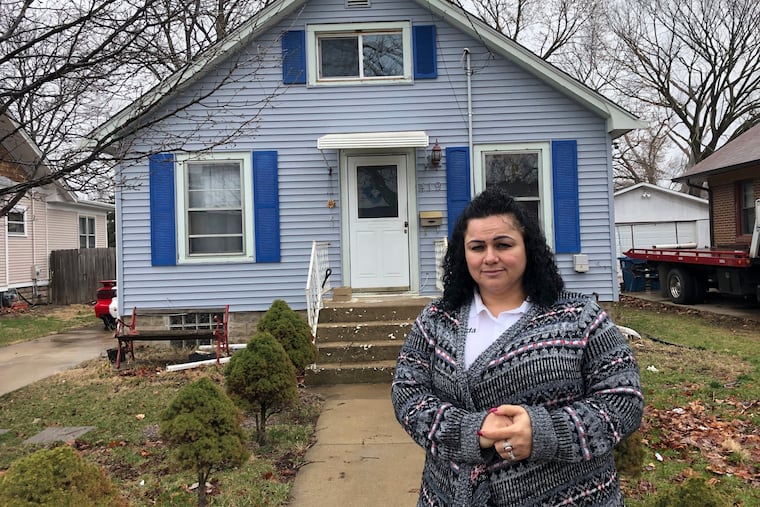Linda Ramirez stands in front of her house in Aurora, Ill., Thursday, April 4, 2019, where she is waiting to learn if a 14-year-old who told police he is Timmothy Pitzen and had escaped kidnappers in the Cincinnati area is really him.