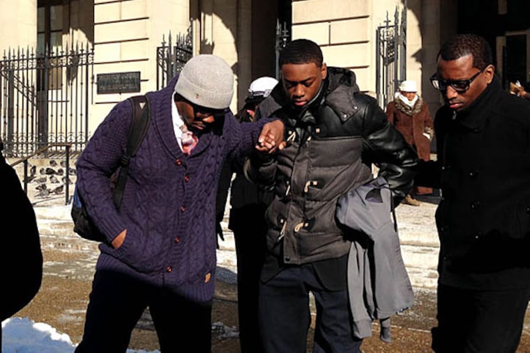 Darrin Manning, 16, gets help leaving Family Court yesterday after a hearing. His case, in which a female officer allegedly ruptured his testicle during frisking, has drawn national attention. HELEN UBIÑAS / DAILY NEWS STAFF