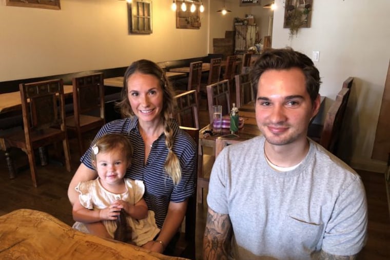 At Lotus Farm to Table in Media, owner Courtney Rozsas and daughter Ophelia with chef Ryan Sulikowski.