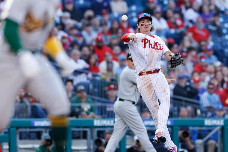 Phillies third baseman Bryson Stott throws across his body on a chopper by Oakland's Tony Kemp in the seventh inning Friday. Stott was charged with a throwing error on the play.