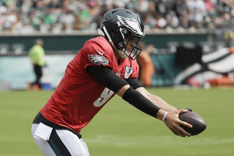 Nick Foles makes a handoff during Saturday's practice, the first he participated in after missing three straight due to neck spasms.