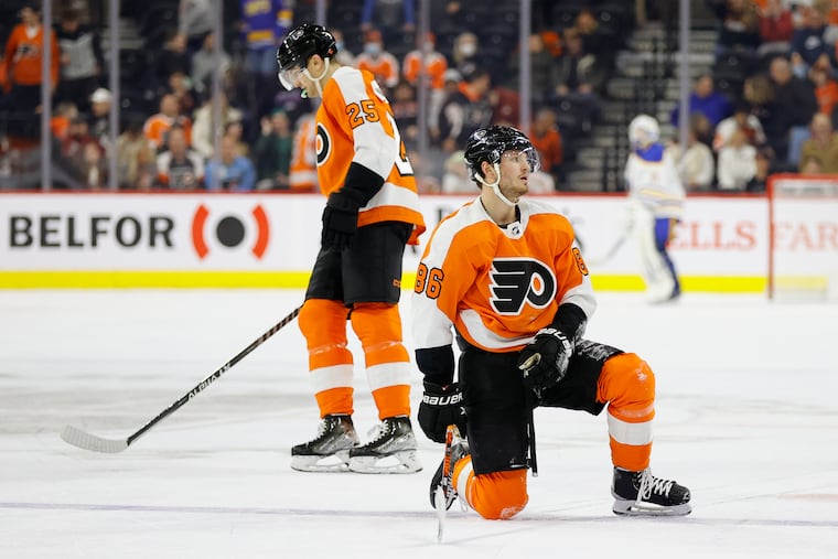 Flyers left wing Joel Farabee kneels on the ice with teammate left wing James van Riemsdyk after Buffalo Sabres right wing Tage Thompson scored a third period empty net goal on Sunday, April 17, 2022 in Philadelphia.