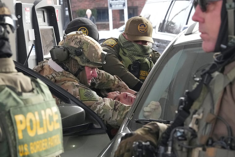 U.S. Border Patrol agents remove a person from their vehicle in St. Paul, Minn., in January.