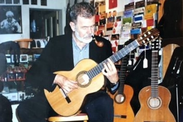 Mr. Page strums the strings at his guitar store in Center City.