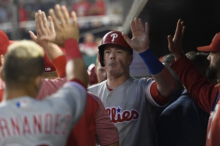 Justin Bour (center) hit a home run in the third inning of Wednesday night's game. Thursday morning, he went on the DL.