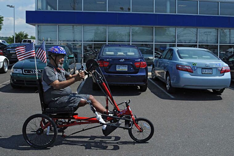 Ellwood "Woody" Allen of West Oak Lane takes his new trike for a spin in the parking lot of Conicelli Hyundai in Conshohocken. He will race it in the National Veterans Wheelchair Games in August. (Clem Murray/Staff)