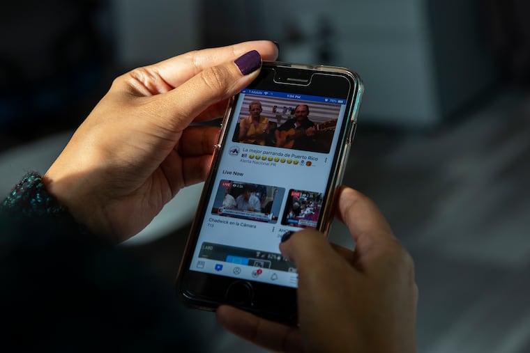 Jesenia De Moya Correa scrolls through Facebook on her phone while at work at the Philadelphia Media Network office on Monday, Nov. 19, 2018. A new Penn-based study tested how social media limits can affect mental health, and found that limiting social media use can decrease loneliness and depression.