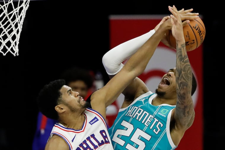 Sixers forward Tobias Harris blocks the basketball on Charlotte Hornets forward P.J. Washington third quarter shot attempt on Saturday, January 2, 2021 in Philadelphia.