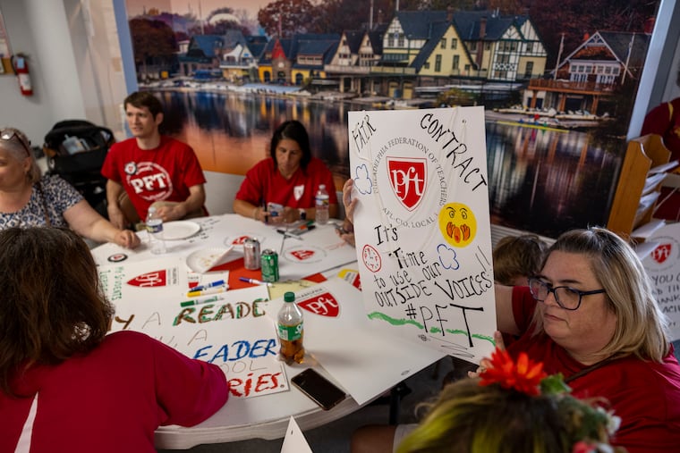 Melissa Finocchiaro, of Northeast Philadelphia, a school secretary at Abraham Lincoln High School, holds up a strike poster she made at the National Association of Letter Carriers building in Philadelphia. The PFT's contract expires Aug. 31. Members have authorized a strike.