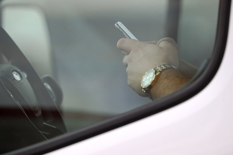A motorist writes a text message while waiting at a red light at the intersection of Western and Diversey avenues Thursday, March 29, 2019, in Chicago, Ill. Nationwide, 3,166 people died from distracted driving nationally in 2017, according to federal data.
(John J. Kim/Chicago Tribune/TNS)