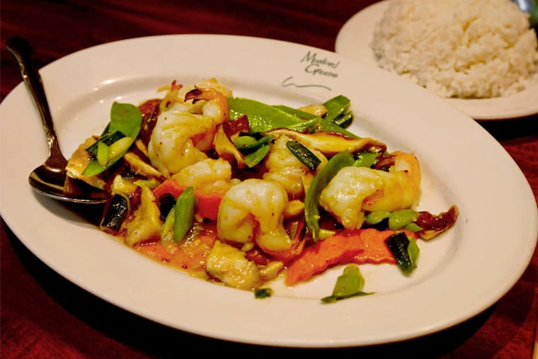Shrimp with shiitakes at Mustard Greens in Queen Village. The slivered mushrooms lend the clear sauce an unexpected earthy layer of umami that amps up the sweetness of those plump butterflied shrimp. (Tom Gralish / Staff Photographer)