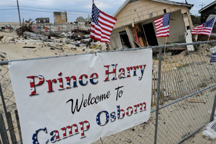 A sign is up in Camp Osborn, Brick Township, May 13, 2013 along the route Prince Harry is expected to take as visits Mantoloking and Seaside Heights on Tuesday. A fire burned some 60 homes in the area as Superstorm Sandy approached the coastline Oct. 29, and continued for at least two days. ( TOM GRALISH / Staff Photographer )