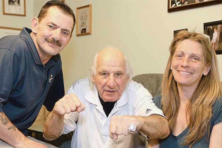 Original Flyer Larry Zeidel shows his old calling cards, flanked by George and Joan Bradley. (Steven M. Falk / Staff Photographer)