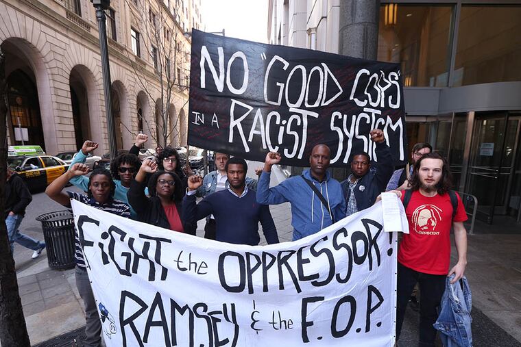The Philly 10 stand outside of the Criminal Justice Center in Philadelphia, Pa. on April 6, 2015. ( DAVID SWANSON / Staff Photographer )