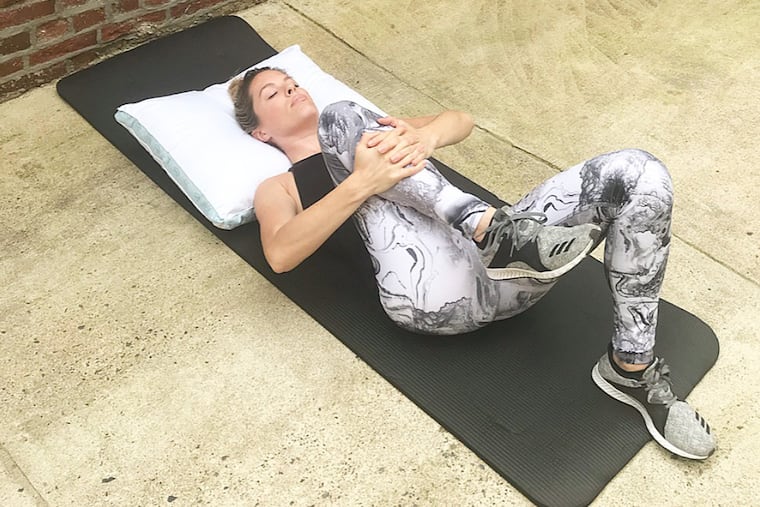 Ashley demonstrates a modified wind relieving pose.